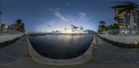 the 360 - view of a body of water and beach at night with the sun behind