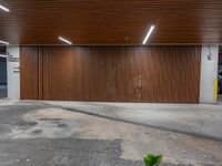 a parking garage with brown slatt and a light on the wall next to it