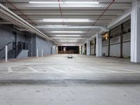 an empty parking space with stairs and lots of empty walls and floor space in a building