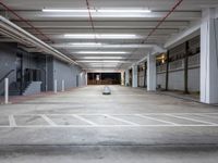 an empty parking space with stairs and lots of empty walls and floor space in a building