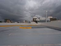 parking spaces on the rooftop of the building under a cloudy sky and clouds in the background