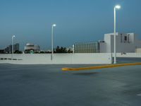 a large parking lot with multiple buildings and street lights, as if they are on the side