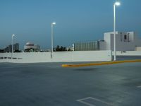 a large parking lot with multiple buildings and street lights, as if they are on the side