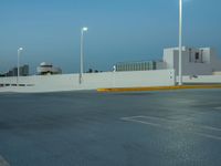 a large parking lot with multiple buildings and street lights, as if they are on the side