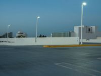 a large parking lot with multiple buildings and street lights, as if they are on the side