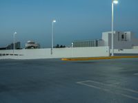 a large parking lot with multiple buildings and street lights, as if they are on the side