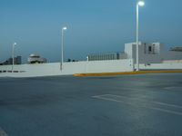 a large parking lot with multiple buildings and street lights, as if they are on the side