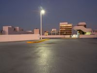 the parking lot is empty of people or vehicles at night time, with street lights on