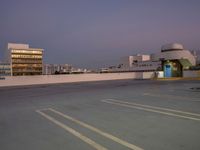 parking lot on roof with buildings and building behind it at sunset time for an urban concept