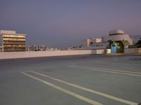 parking lot on roof with buildings and building behind it at sunset time for an urban concept