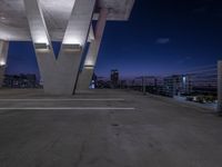 an empty parking space is located near a bridge that crosses a bridge that stretches into the city