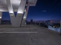 an empty parking space is located near a bridge that crosses a bridge that stretches into the city