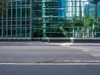 the street with no traffic and buildings behind it is empty, clear with the glass walls