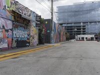 a graffiti covered street corner is shown in this image with cars parked along the curb