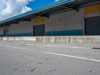 an empty lot with an empty parking lot in the background and clouds in the distance