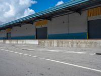 an empty lot with an empty parking lot in the background and clouds in the distance