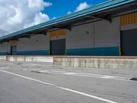 an empty lot with an empty parking lot in the background and clouds in the distance