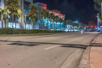 a long exposure photo of a road with traffic on the sidewalk at night in miami beach, florida