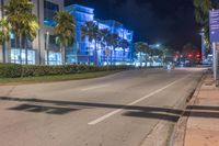 a long exposure photo of a road with traffic on the sidewalk at night in miami beach, florida