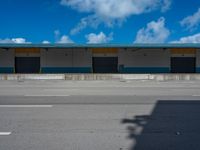 an empty lot with an empty parking lot in the background and clouds in the distance