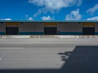 an empty lot with an empty parking lot in the background and clouds in the distance