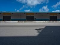 an empty lot with an empty parking lot in the background and clouds in the distance