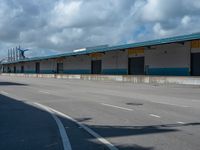 an empty lot with an empty parking lot in the background and clouds in the distance