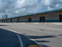 an empty lot with an empty parking lot in the background and clouds in the distance