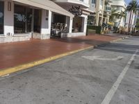 this is the outside sidewalk and parking area of an upscale shopping center in sunny beach, florida