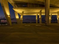 the lights are glowing on to some concrete structures at night time with no light on them