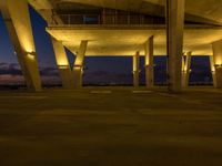 the lights are glowing on to some concrete structures at night time with no light on them