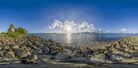 the view from an overlook in an underwater view of a sea and city across a rocky beach