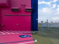 a pink building has an air conditioning unit inside of it's doorway, on a sidewalk