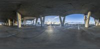 fisheye image of the empty parking lot for the bus station and mountains seen from across the street