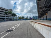 an empty lot with an empty parking lot in the background and clouds in the distance