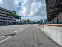 an empty lot with an empty parking lot in the background and clouds in the distance