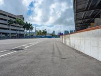 an empty lot with an empty parking lot in the background and clouds in the distance