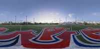 a field with a mural on it in front of the sun with the word usa painted on it