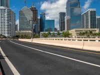 an empty freeway going to downtown tampa with high rise buildings in the background to the left