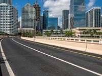 an empty freeway going to downtown tampa with high rise buildings in the background to the left