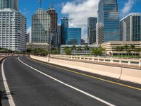 an empty freeway going to downtown tampa with high rise buildings in the background to the left