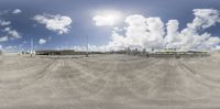 the view of an empty parking lot from a fish eye lens looking up at clouds