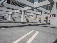 a large concrete building with several openings above it on a street in an area called a parking lot