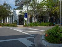 the entrance to an office is shown from the street corner, with a traffic light on