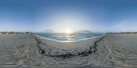 a large empty beach with some sand near the ocean in this 360 - turn photo