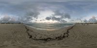 a panoramic picture taken with an object that is upside down on the beach