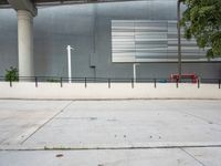 a picture of a concrete sidewalk with a fire hydrant and tree in the corner