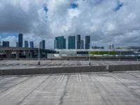 an empty parking lot and a city skyline in the background in the daytime time,