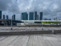 an empty parking lot and a city skyline in the background in the daytime time,