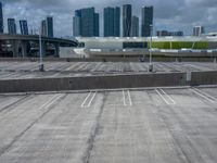 an empty parking lot and a city skyline in the background in the daytime time,